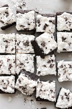 chocolate brownies with white frosting and oreo cookies on top, cut into squares