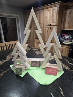 some wood pieces are stacked on top of each other in the shape of christmas trees