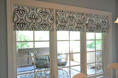 a window with roman shades made from target fabric and tension rods