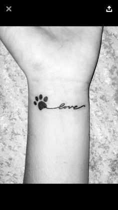 a dog paw with the word love written on it's left wrist tattoo design