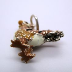 "This three-dimensional, sterling silver Rooster charm is hand-enameled and beautifully detailed. It features brown and black plumage, a white chest, tan neck, white head, black eyes, and a red cowl. Made by Brown County Silver. Vintage but in brand new, never worn condition. Charm height: 3/4\" high Charm height with ring: 1\" high Weight 4.2 grams See more @ https://www.etsy.com/shop/Brocosi" Novelty Pendant Jewelry With Charms, Unique Silver Charms For Gifts, Novelty White Sterling Silver Jewelry, White Sterling Silver Novelty Jewelry, Novelty Sterling Silver Charm Jewelry, Novelty Sterling Silver Jewelry With Charms, Novelty Silver Pendant Jewelry, Brown County, White Chest