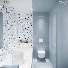 a modern bathroom with blue walls and white fixtures, including a toilet in the center