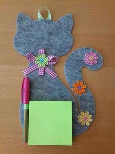 a felt squirrel ornament with a notepad and pen