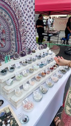 the table is covered with many items for sale