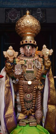 an elaborately decorated statue in gold and green