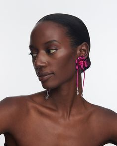 Crafted with meticulous attention to detail, The Ophelia Flower Earrings feature an abstract floral design and silk cord detail with delicate dangling crystal drops. The vibrant pink hue adds a pop of color to your ensemble, instantly elevating your style. Why You'll Love It These earrings are a true blend of elegance and playfulness, designed to make a statement wherever you go. Details Ceramic coated Silk cord Crystal Sterling silver posts Butterfly fastening and post back for pierced ears Ite Elegant Pink Flower Earrings For Evening, Pink Flower Earrings For Evening, Pink Elegant Flower Earrings For Evening, Luxury Flower Drop Earrings For Party, Chic Pink Flower Shaped Earrings, Luxury Statement Flower Drop Earrings, Artistic Multicolor Flower Drop Earrings, Pink Flower-shaped Evening Jewelry, Suede Jewelry