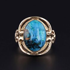 This vintage ring features a vibrant chrysocolla cabochon set in 10k gold. The mounting dates to the 1920s, while the stone is a later replacement.  The face of the ring measures 0.7 inches by 0.65 inches wide, and it is in great condition.  The ring is currently a size 6, but it can be resized free of charge. We have many other fantastic offerings of period fine jewelry posted on our Etsy store, so please consider browsing our other items. We send all items in individually packaged gift boxes a Vintage Chrysocolla Rings For Gifts, Vintage Yellow Gold Turquoise Cabochon Ring, Antique Yellow Gold Turquoise Cabochon Ring, Blue Chrysocolla Cabochon Ring, Vintage Blue Cabochon Turquoise Ring, Antique Bouquet, Chrysocolla Ring, Diamond Bows, Head Ring