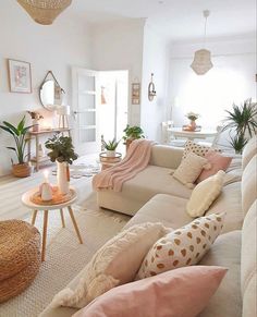 a living room filled with lots of furniture and pillows on top of it's couches