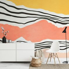 a living room scene with focus on the wall painted in shades of orange and pink