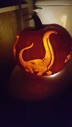 a pumpkin carved to look like a lizard