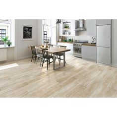 a kitchen with white walls and wooden floors