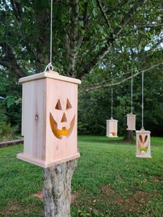 some kind of wooden lantern hanging from a tree