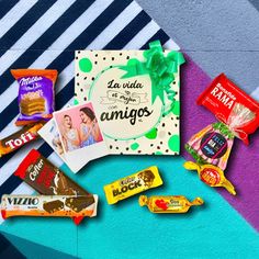 an assortment of chocolates and candies on a colorful background with the words la vie de los amigos