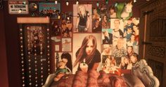 a bed with many pictures on the wall and lights strung from it's headboard