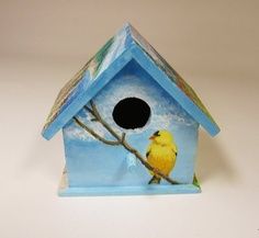 a bird house with a yellow bird on it