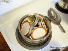 there are many different items in the container on the stove burners and spoons