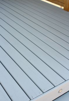 the bottom half of a blue deck with white slats