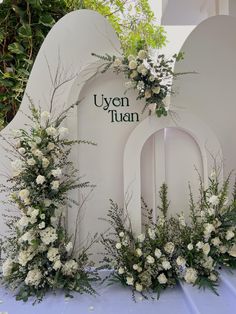 white flowers and greenery are on display at the event