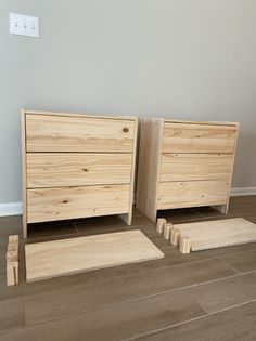 two wooden dressers sitting next to each other on the floor