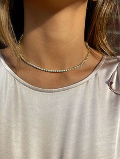 Here is a woman wearing a gold jewelry necklace Tennis Necklace Layered, Accessories 2023, Romantic Date Night, Necklace Layered, Gold Jewelry Necklace, Cz Necklace, Romantic Date, Glamorous Style, Glamorous Look