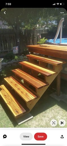 a wooden deck with stairs built into it in the yard next to a swimming pool