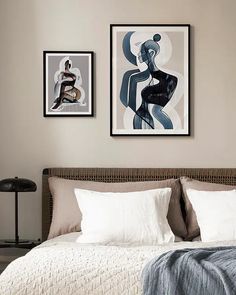 two framed pictures hang above a bed in a bedroom