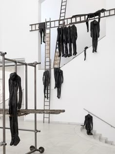 an art installation with clothes hanging on the rails