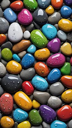 colorful rocks with water droplets on them are shown in close up view, and the colors appear to be multicolored