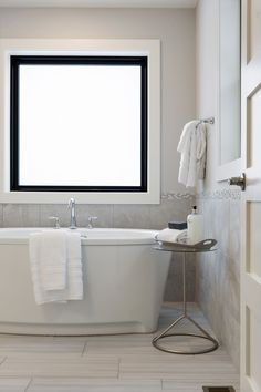 a white bath tub sitting next to a window