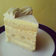 a piece of cake sitting on top of a white and black plate with a fork