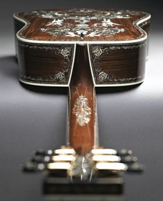 a close up of an acoustic guitar on a table