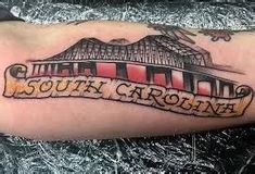 a man with a tattoo on his arm that says south carolina in an old - fashioned script