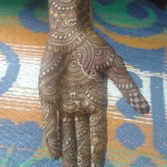 a henna hand with intricate designs on it