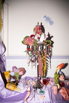 a table topped with lots of different types of flowers