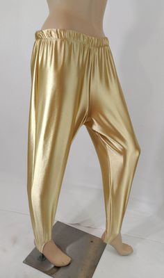 "70's Satin Pants Women's Disco Stir-ups Sporty Elastic High Waist Super RARE Perfect Condition Vintage by SHANNA FASHIONS size M USA COOL GORGEOUS RARE! Wow Disco pants!  1970's elastic HIGH waist thick spandex satin light gold beige stir-up disco leisure pants. Very sturdy. Super high quality. Made in USA vintage. Amazing condition.   Easy to wear casual chic vintage for the disco sporting life. MEASUREMENTS: Length - 38\" Waist - 27\" elastic waist unstretched Inseam - 28\" Hips - 38\" MODEL Gold Stretch Full Length Bottoms, Gold Full-length Pants For Spring, Gold Stretch Trousers, Carrie White, Silky Pants, Silver Pants, Disco Pants, 70s Disco, Satin Pants