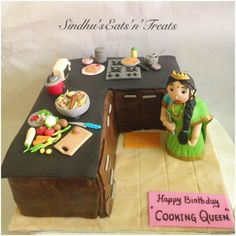 a birthday cake with a woman cooking in the kitchen on it's counter top