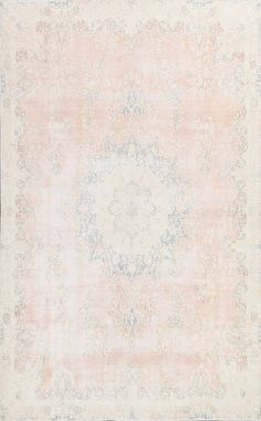 an antique rug with pink and blue colors