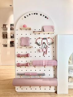 a white wall with pink items on it