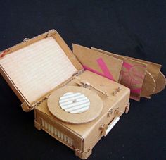 an open cardboard box with a record player inside