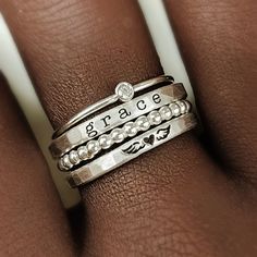 Mother's Day Gift | Personalized stackable ring set, engraved with a name, date, or special word.  Metal: 14 gold filled, 14k rose gold filled, or .999 fine silver Dimensions: name rings are 2mm tall on average, but our rings are handmade so variations will occur. The beaded ring is 2mm, and the birthstone is 2mm on a 1mm band Font: lowercase typewriter, lowercase cursive, or uppercase bold block. If you leave one name, we will engrave the heart/wings on the second ring. Unsure what size you nee Cheap Stackable Name Rings For Women, Custom Name Adjustable Stackable Rings, Adjustable Stackable Rings With Custom Name, Adjustable Stackable Initial Ring As Gift, Adjustable Stackable Initial Ring For Everyday, Adjustable Engraved Sterling Silver Stackable Rings, Personalized Adjustable Rings For Everyday, Everyday Meaningful Hand Stamped Stackable Rings, Mother's Day Adjustable Stackable Rings With Custom Name