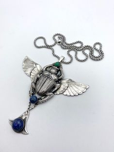 Elegant Winged Metal Jewelry, Collectible Silver Art Deco Jewelry, Nickel-free Silver Winged Jewelry, Art Deco Silver Metal Necklace, Art Deco Metal Pendant Jewelry, Winged Scarab, Revival Design, Old Factory, Egyptian Revival