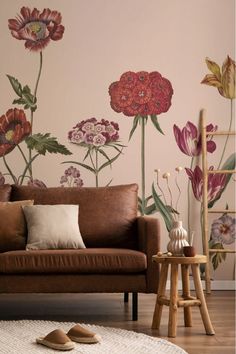 Living room with a bold floral wall mural, a brown leather sofa, and natural decor elements, creating a cozy, nature-inspired ambiance. Poppy Mural, Living Room Floral Wallpaper, Wildflower Mural, Poppies Wallpaper, Floral Mural, Poppy Wallpaper, Wallpaper Large, Van Gogh Almond Blossom