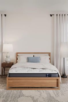 a bed with white sheets and pillows in a bedroom next to two lamps on either side of the bed