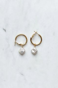 For a night that sparkles, these Champagne Hoop Earrings will be your go-to accessory! These gold hoops feature an elegant pearl pendant that will add tasteful style to every occasion. Let your eyes (and ears!) do the talking with these hoops - cheers to you! Metal Hoop Earrings With Pearl Charm For Gift, Metal Hoop Earrings With Pearl Charm As A Gift, Gold Plated Hoop Earrings With Pearl Pendant As Gift, Gold Metal Hoop Earrings With Pearl Charm, Hoop Pearl Earrings With Pearl Pendant, Gold Dangle Hoop Earrings With Pearl Pendant, Gold Small Hoop Earrings With Pearl Pendant, Small Hoop Earrings With Pearl Pendant For Gift, Small Hoop Earrings With Pearl Pendant As Gift