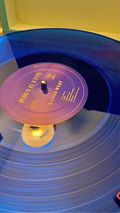 the record player is spinning around on it's turntable with an illuminated disc