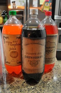 three bottles of pumpkin juice sitting on top of a counter