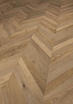 an image of wood flooring that looks like herringbones or chevron lines