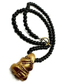 Bear this monk talisman for deepened meditation or for protection from evil spirits. The necklace itself is inspired by rosaries with alternating beads that can be used for meditative practice. The pendant is made of bronze and measures about 1 and half inch. Measures 24” long and has a bronze toggle clasp. The beads are black onyx. Spiritual Onyx Beads Jewelry 8mm, Spiritual Obsidian Beaded Jewelry, Gold Spiritual Obsidian Jewelry, Spiritual Obsidian Jewelry For Meditation, Black Amulet Jewelry For Meditation, Obsidian Beads Jewelry For Meditation, Obsidian 8mm Beads Jewelry For Meditation, Onyx Beaded Jewelry For Meditation, Spiritual Onyx Bead Necklaces