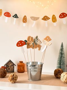 there is a bucket with cake toppers in it on the table next to decorations