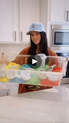 a woman in a baseball cap holding a plastic container filled with food